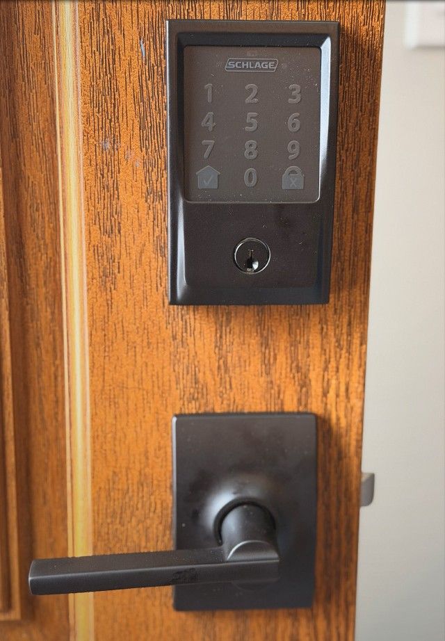 Schlage touchscreen deadbolt and lever on a wood door, the kind of same-night upgrade we fit in New Brunswick, NJ