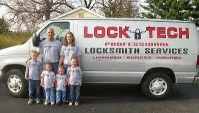 The Lock-Tech family in matching shirts beside the company van