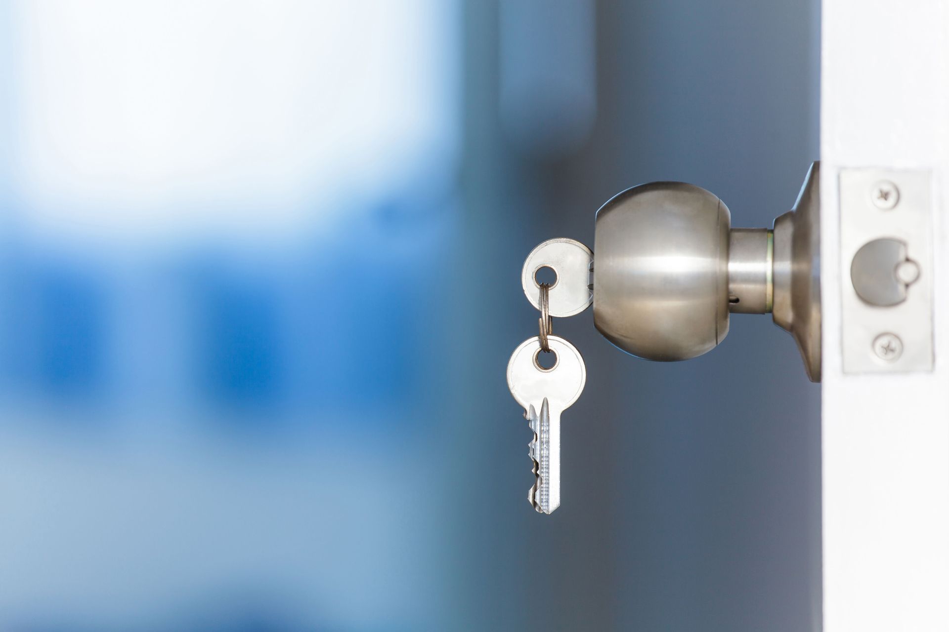 Close-up of a residential door lock and keys