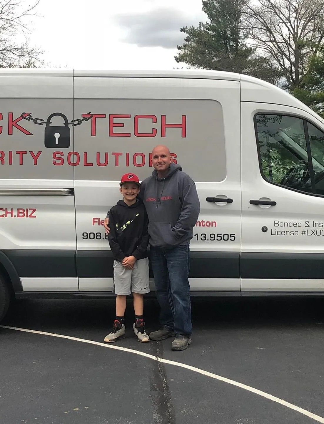 Lock-Tech's owner with his son in front of the company van